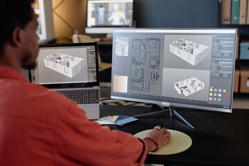 Leinwandbilder - Person analyzing architectural designs on computer screens at office workspace, focusing on detailed models and layouts for a project. Engaging in work through high-end technology