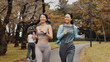 © peopleimages.com - Women, running and bonding for fitness, cardio and training for body goals, wellness or active in morning. Outdoor, smile and workout for Japanese friends, health and together for exercise routine