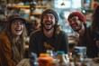 © Umi Sakina - Three happy young adults laughing together at a cafe table.