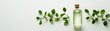 © Prichachai - A bottle of essential oil surrounded by green leaves on a light background, highlighting natural beauty and organic skincare products.