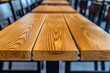© InkCrafts - Close-up of polished wooden tabletop in a restaurant, showcasing the rich grain patterns.