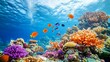 © Wiryo - Vibrant coral reef teeming with colorful fish and diverse marine life under clear blue water.