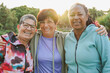 © Sabrina - Happy multiracial senior women hugging each other in front of camera at city park - Joyful healthy elderly people and sport concept