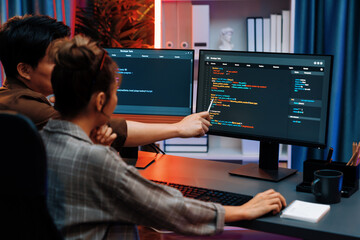 Wall Mural - smart it developer looking at coding program application on computer screen of online website at bac