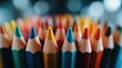 ©  lukaPixMedia - A vibrant collection of sharpened, colorful pencils arranged in a circular pattern, highlighting their sharp tips and varied hues against a blurred background.