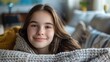 © Z A C - The image depicts a young girl with long brown hair wrapped in a cozy blanket exuding a warm and inviting atmosphere.