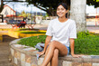 © Carlostock - Young Latina woman in the park during the afternoon, sitting and enjoying her vacation, feeling free and calm