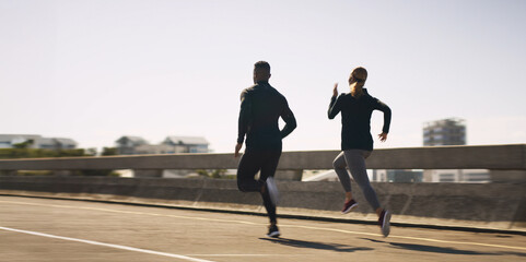 Poster - Outdoor, couple of friends and running for fitness in bridge for health, wellbeing and self care. City, people and jog with support or care for exercise, training and workout on highway road