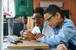© Dorde - Diverse Mid-Adult Teacher and Child Engage in 3D Printing Workshop