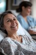© bvbflo1 - A smiling woman in a hospital bed is comforted