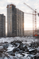 Idle cranes and unfinished buildings reflect economic stagnation at abandoned construction site