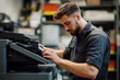 © Bohdan - Technician performs maintenance on office printer in a modern workspace