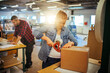 © Geber86 - Warehouse workers packing boxes and smiling at work