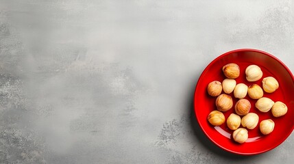 Wall Mural - Delicious round pastries arranged neatly on a vibrant red plate against a textured gray background