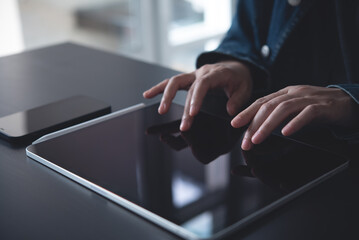 Wall Mural - close up of woman hand using digital tablet, finger touching screen on office table, digital educati