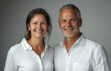 Wall Mural - The man and woman casual attire business shirt and warm smiles highlight a simple yet strong business partnership standing together on white background.