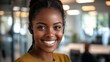 © Vader Stocker - Smiling Black Woman Wearing Earbuds in an Office Setting