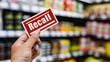 © 楠 刘 - Hand holding a 'Recall' sticker on a packaged food item, highlighting the importance of food safety and consumer protection in product management.