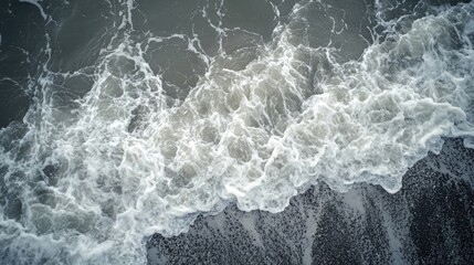 Sticker - Aerial view of ocean waves creates a stunning scene, with foamy white sea waves gracefully flowing onto the beach, under abstract, cloudy lighting, providing ample copy space.