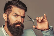 © Yevhen - Man holding scissors. Barber scissors. Barber scissors, vintage barbershop