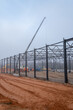 © Edijs - Industrial Construction Site with Steel Frame Structure