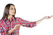 © peshkova - Woman wearing red plaid shirt gesturing with her open hand. Isolated on a white background. Concept of presentation, promotion, or guidance