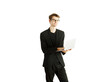 © peshkova - Man in formalattire holding a laptop, smiling confidently on a white background. Represents modern business, professionalism, and technology