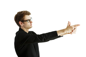Poster - Side view of a man in glasses, wearing a dark suit, making a hand gesture resembling a pointing motion. Isolated on white background, concept of communication