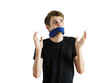 © peshkova - Man int-shirt gagged with blue cloth, gesturing expressively with hands on white background. Concept of silence, restriction, or censorship