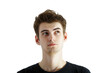 © peshkova - A young man with brown hair in casual attire looking upward thoughtfully, isolated on a white background, concept of pondering or curiosity