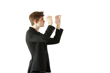 Poster - A young man wearing asuit making hand gestures, shown in side profile on a white background. Represents communication or interaction concepts