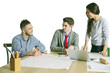 © peshkova - Three young people collaborating at a table, discussing ideas. White background, casual attire, teamwork, and creativity concept