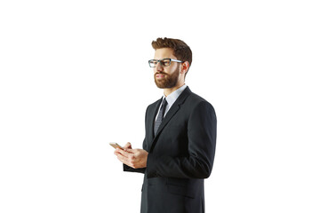 Poster - A professional man in a formal suit with glasses holding a smartphone, isolated on a clean white background. Concept of business and communication