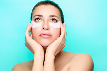 Wall Mural - Woman enjoying beauty treatment with eye patches in spa setting