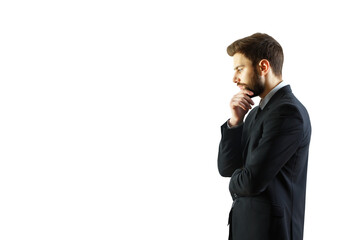 Poster - Side view of a man in formal suit, hand on chin, isolated on white background. Concept of thinking, decision-making, and professionalism