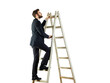 © peshkova - Man in a suit climbing a wooden ladder, isolated on a white background. Clean and professional image symbolizing success and career growth