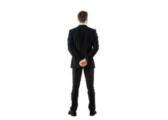 Poster - Rear view of a businessman in a formal suit standing with hands clasped behind his back, isolated on a clean white background. Professional concept