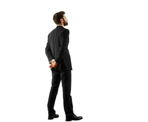 Poster - Man in a formalsuit standing with hands clasped behind on a white background, isolated view. Represents professionalism and business style