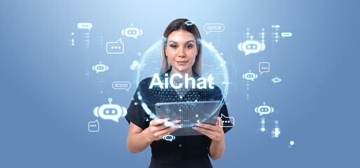 Wall Mural - woman holding tablet with ai chat interface on blue background.