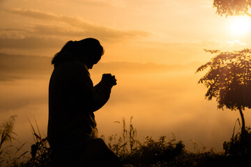 Wall Mural - Woman in silhouette, worship in prayer at sunrise with sun rising in summer sky, embracing her faith amidst beauty of nature. worship, sunrise, woman, silhouette, sky, sun, nature, summer, prayer.