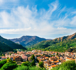 Wall Mural - Mountain town view. Mountain landscape of  beautiful village in Sicily, Italy. A town in a beautiful mountain valley. Mountain valley town during sunset in evening light