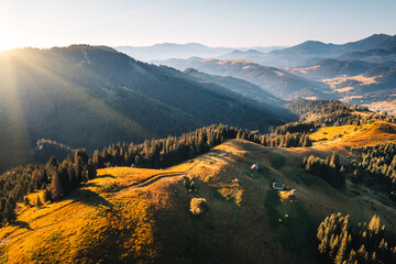 Wall Mural - The sun's rays illuminate the green slopes in the mountainous area. Carpathian mountains, Ukraine, Europe.