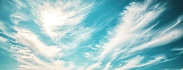Aufkleber - A serene sky filled with soft, wispy clouds against a bright blue backdrop, creating a tranquil and uplifting atmosphere.