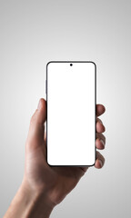 Poster - Hand holding a smartphone with an isolated screen against a gray background, perfect for promoting apps, showcasing mobile technology, or mockup designs