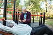 © Marko Geber - Senior men exercising together at outdoor fitness park