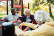 © Marko Geber - Senior men socializing and relaxing at outdoor park fitness area