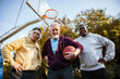 © Marko Geber - Senior men playing basketball outdoors team huddle