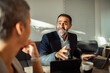 © Geber86 - Team collaboration in modern office space with diverse professionals using laptops and discussing project