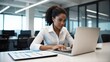 © Htet Wai Phyo - Young Latin businesswoman using computer, working in modern office. Focused African American woman doing online business data market analysis, planning tech strategy at laptop pc. copy space