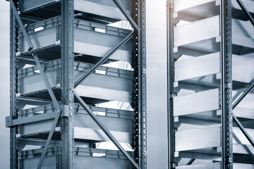 Fototapete - Two metal racks with shelves and a white background. The shelves are empty. The racks are in a warehouse